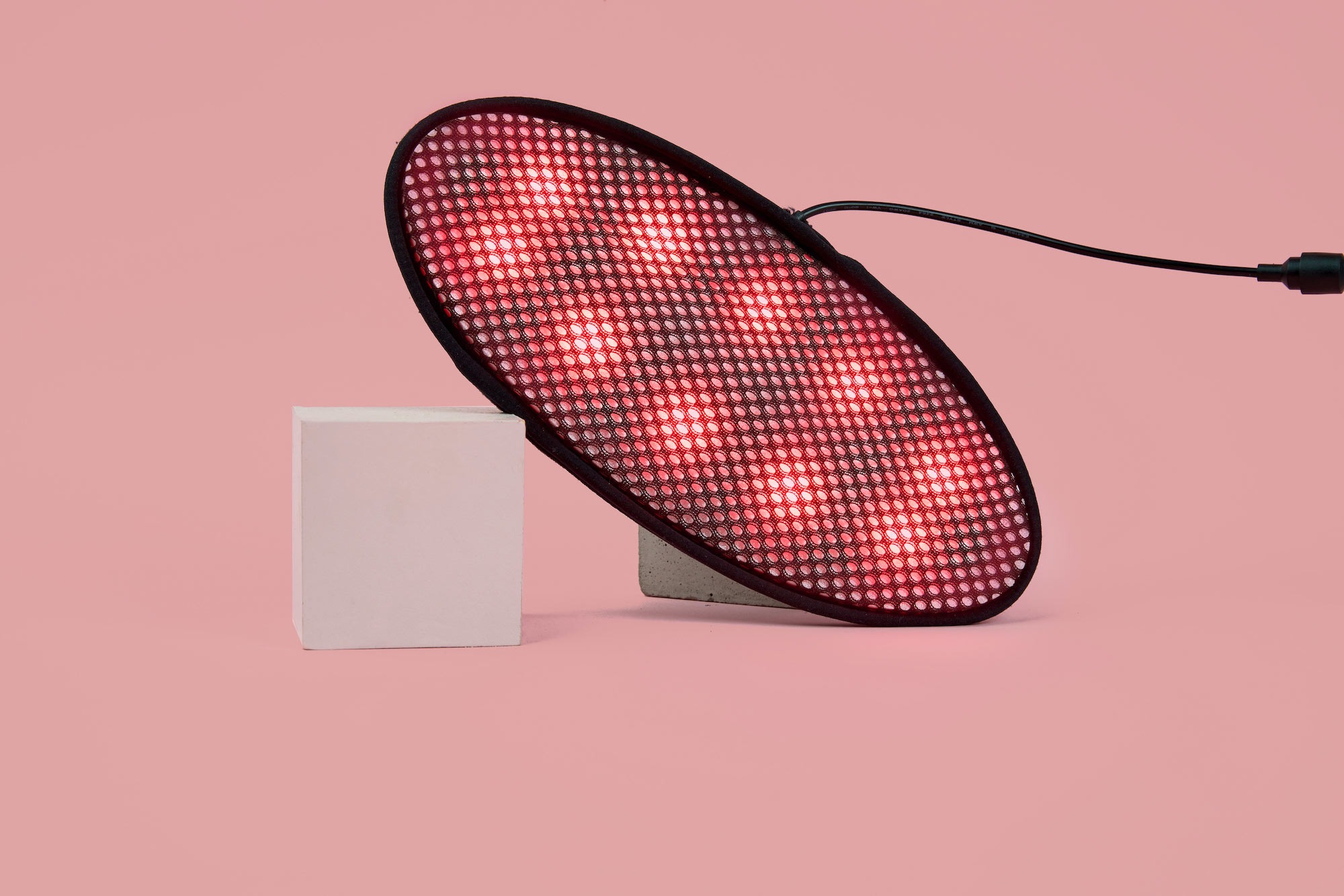 A red light device propped up on blocks.