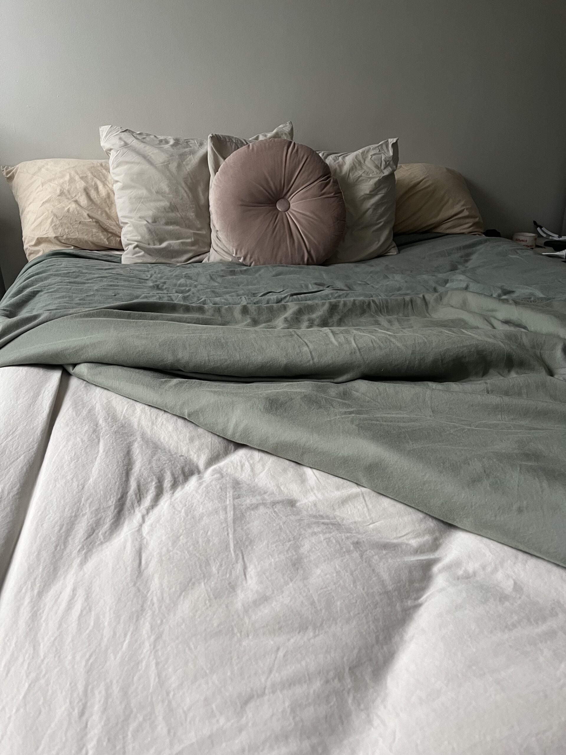 Close up of a made bed.