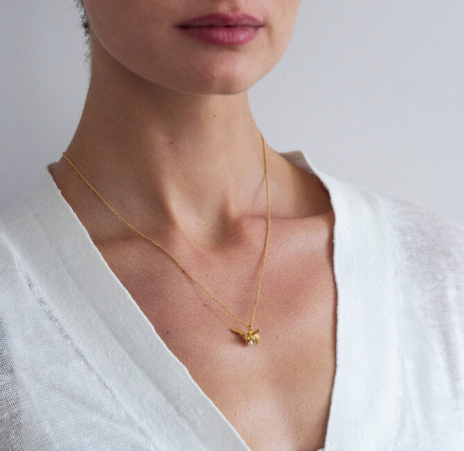 A model wearing a necklace from Alex Monroe