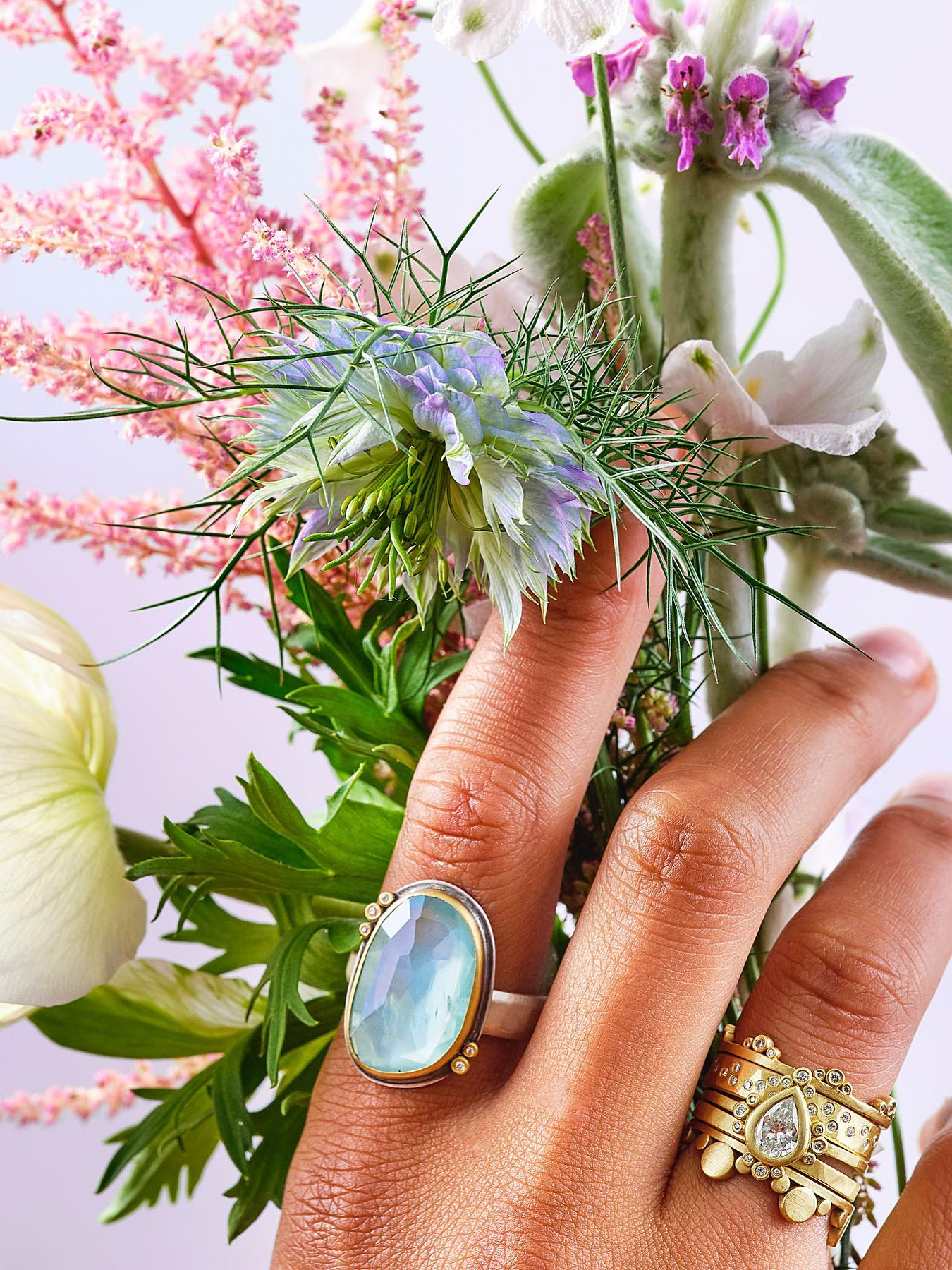 A model's hands wearing rings from Ananda Khalsa