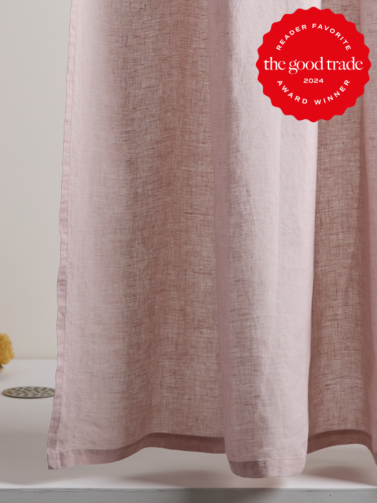 Light pink curtain with a texture hangs down, with a red circular "Reader Favorite - Award Winner - The Good Trade 2024" badge displayed in the upper right corner.
