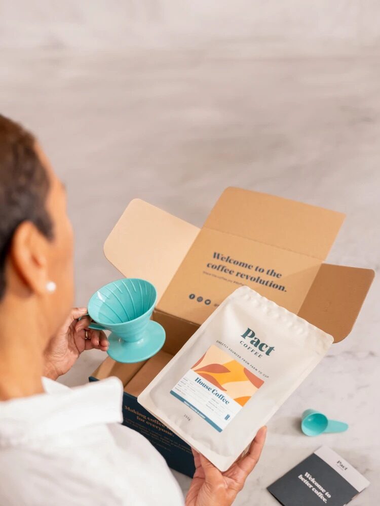 A Pact subscription box being opened.