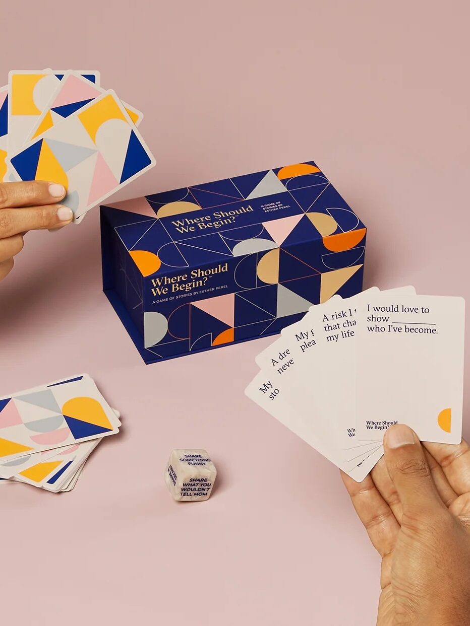 A close up of the Where Should We Begin? card game being played by two people.