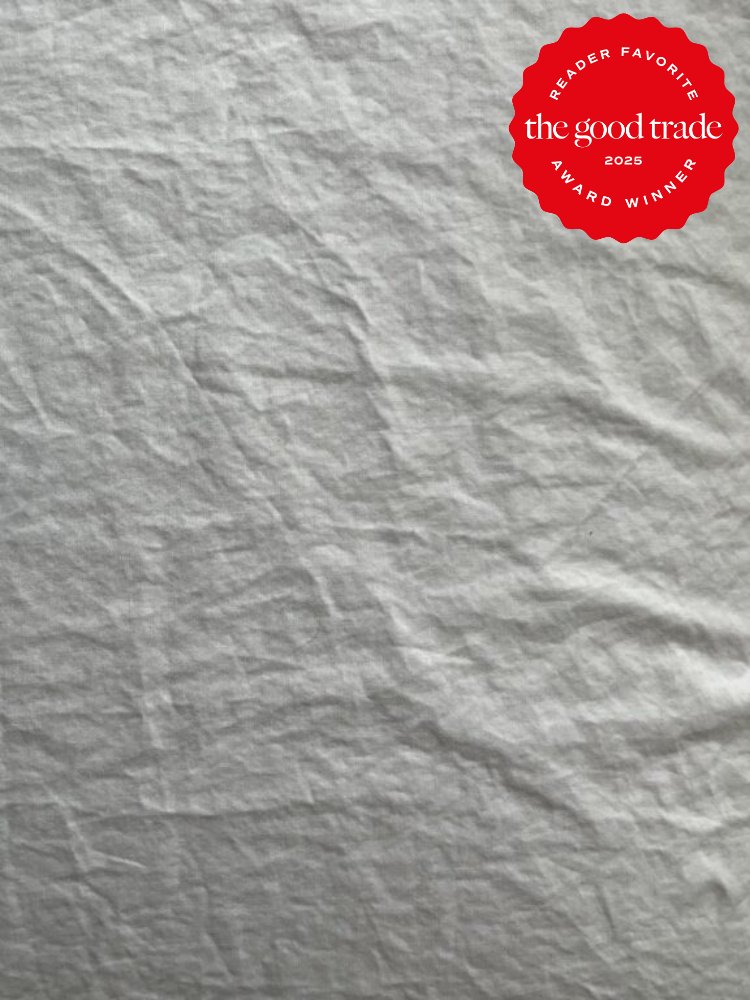 Wrinkled gray fabric background with a red badge in the top right corner displaying "Reader Favorite - the good trade 2025 Award Winner.