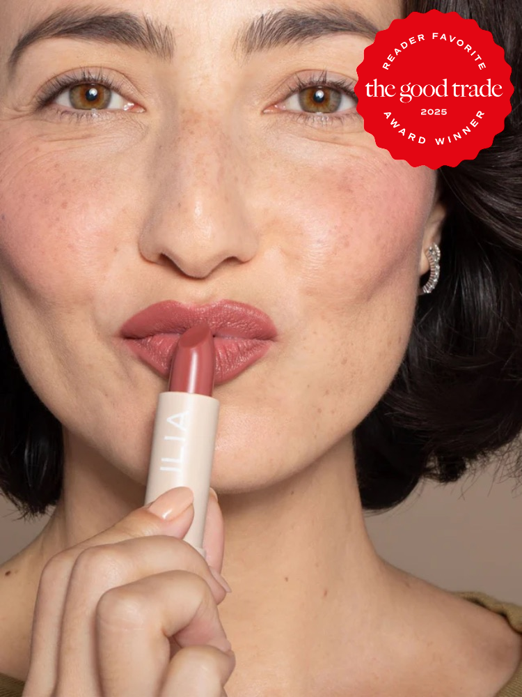 Person applying pink lipstick, marked as "Reader Favorite" award winner from The Good Trade 2025.