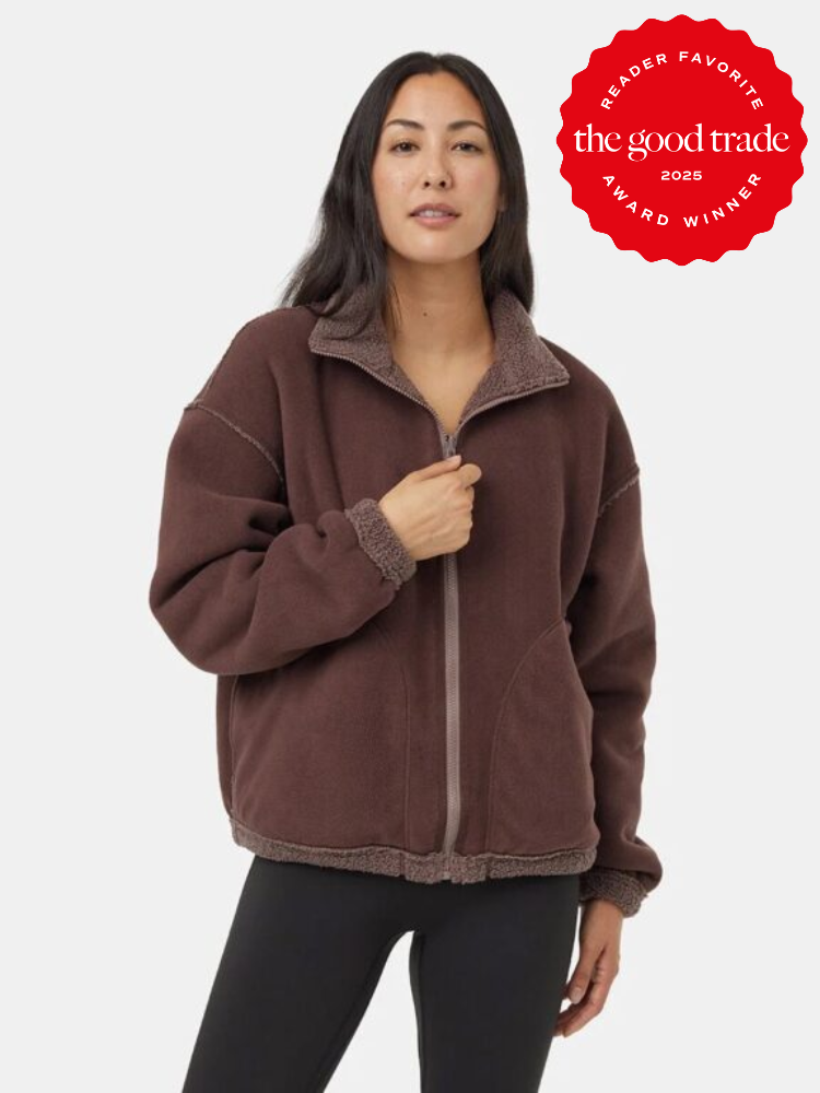 Person wearing a brown fleece jacket and black pants. A circular red badge in the corner reads "Reader Favorite, the good trade, 2025 Award Winner.