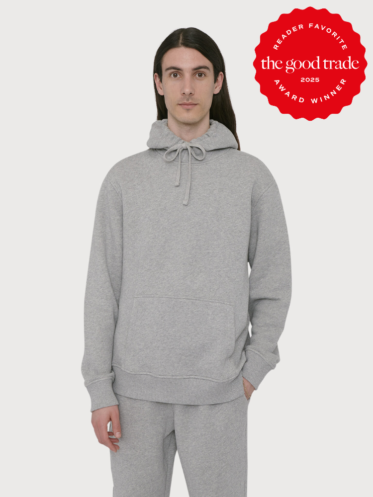 Person wearing a gray hoodie and matching sweatpants standing against a plain background. Red badge on the image reads "Reader Favorite The Good Trade Award Winner 2025.