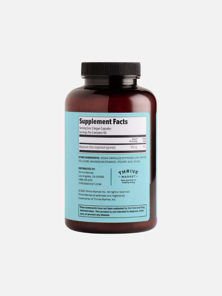 Dark brown bottle showing a supplement facts label, indicating vegan capsules and magnesium glycinate. Label includes serving information and manufacturer details.