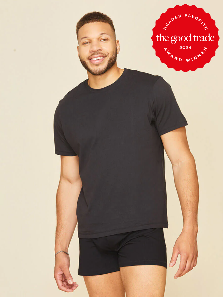 A man wearing a black t-shirt and black boxer briefs stands against a plain background. A red badge in the corner reads, โReader Favorite, The Good Trade, Award Winner 2024.โ.