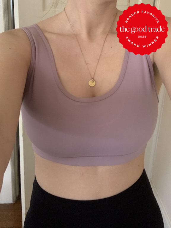 A person wearing a mauve sports bra and black bottoms stands indoors. A red badge in the top right corner reads, "The Good Trade 2025 Reader Favorite Award Winner.