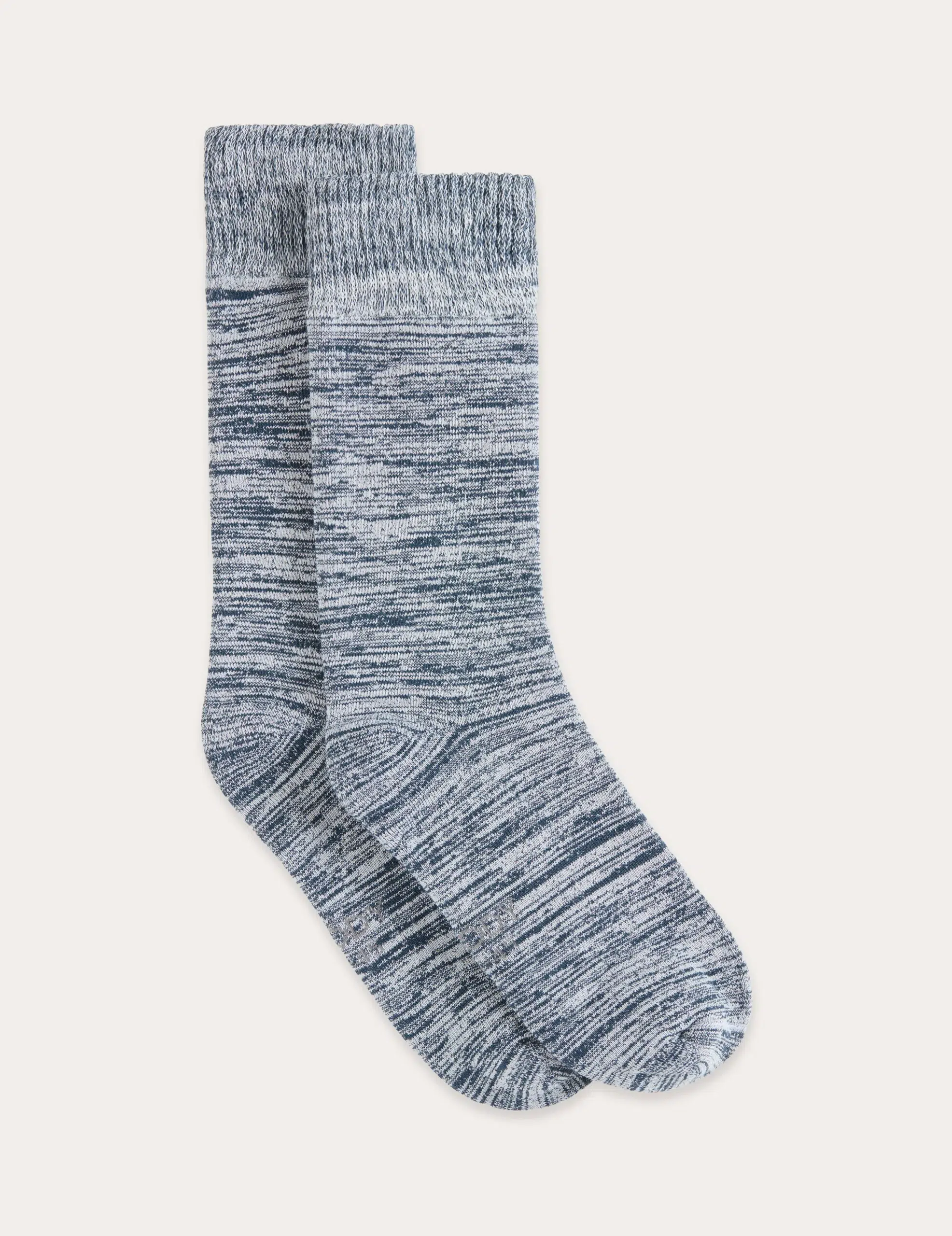 A pair of gray and white marled crew socks are laid flat, overlapping each other, on a plain light background.