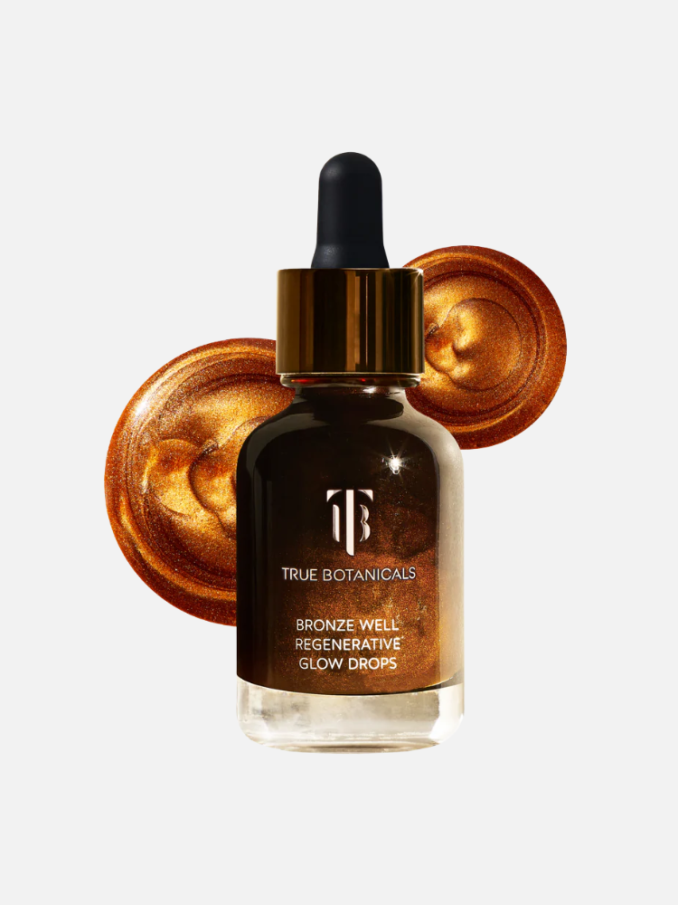 A bottle of True Botanicals Bronze Well Regenerative Glow Drops with a gold dropper cap, shown in front of swirled bronze liquid makeup.