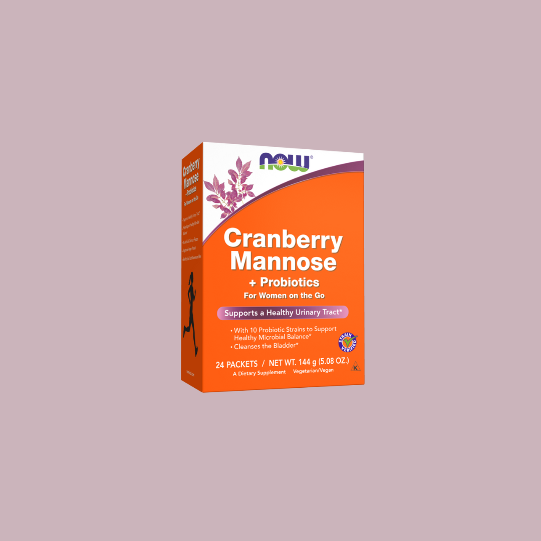 A box of NOW Cranberry Mannose + Probiotics dietary supplement for women, containing 24 packets, displayed on a plain light mauve background.