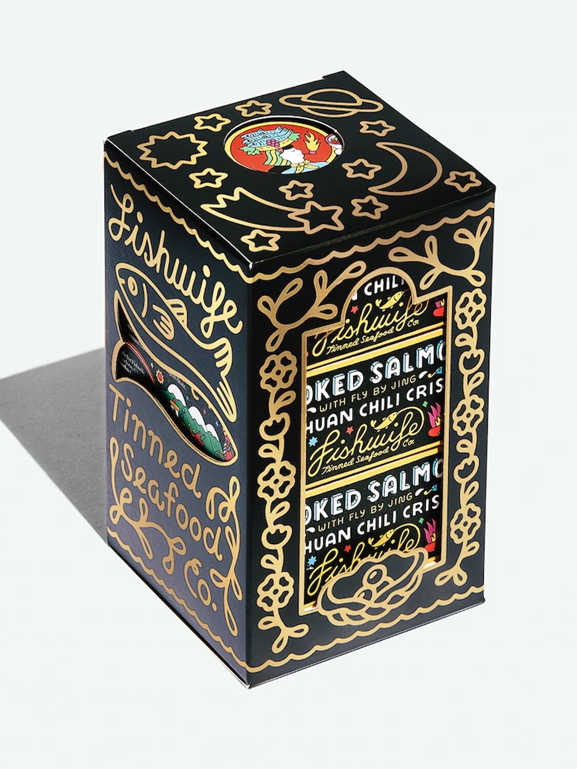 A black box of Fishwife Smoked Salmon displays gold illustrations and text, including a fish graphic and product details, with a chili pepper illustration on the top.