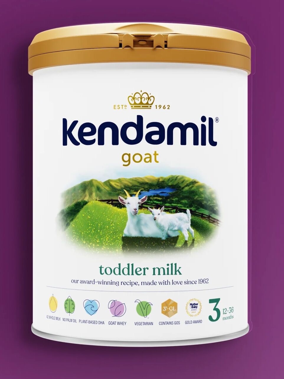 A can of Kendamil goat toddler milk formula with a gold lid is displayed against a purple background. The label features a goat in a meadow and product information.